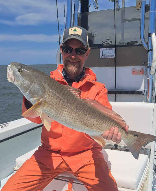 Dad catches big red rum.