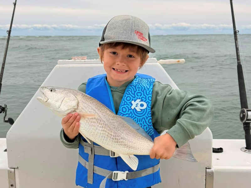 Father and son with father's huge red drum.
